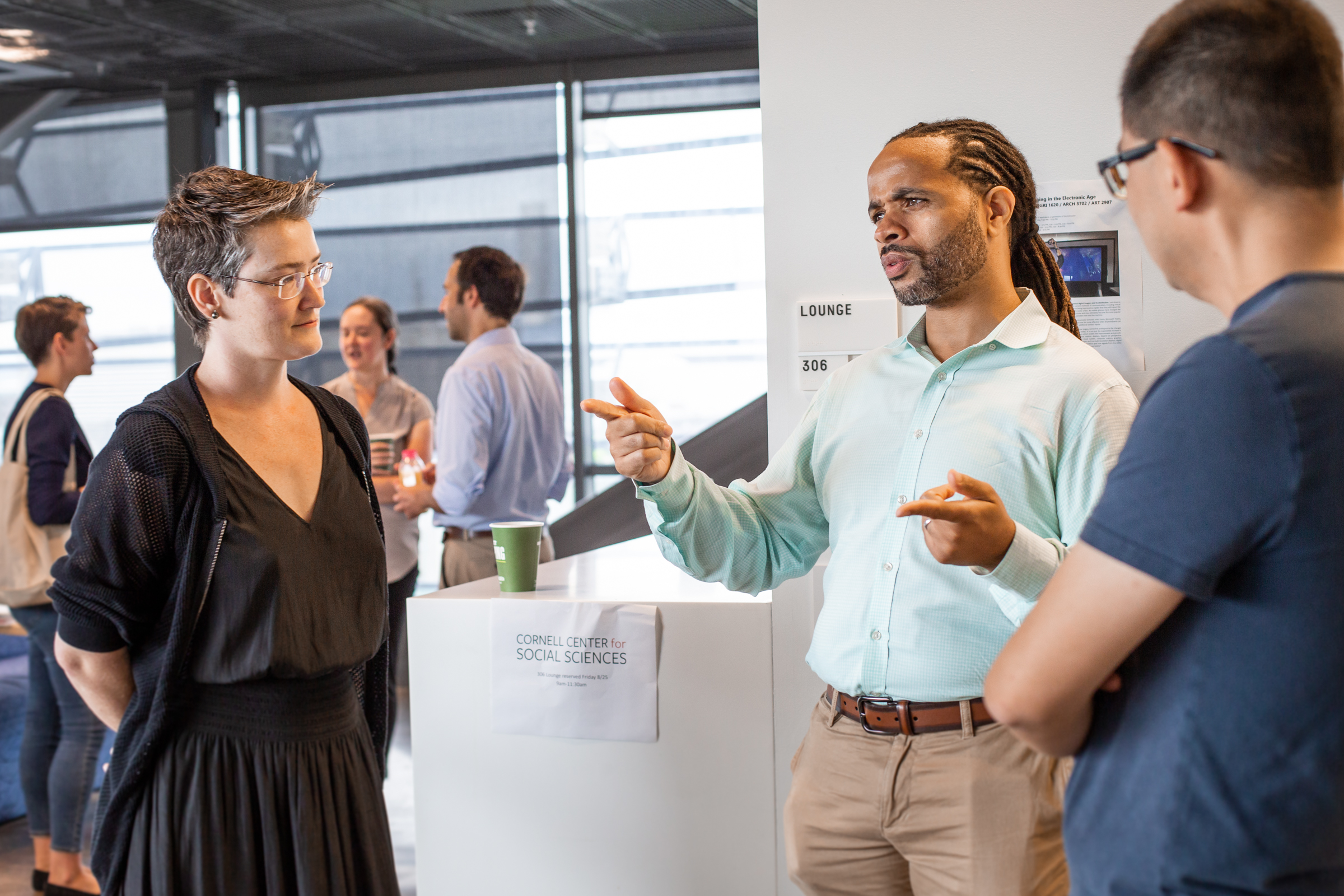 Image of three faculty fellows having a conversation