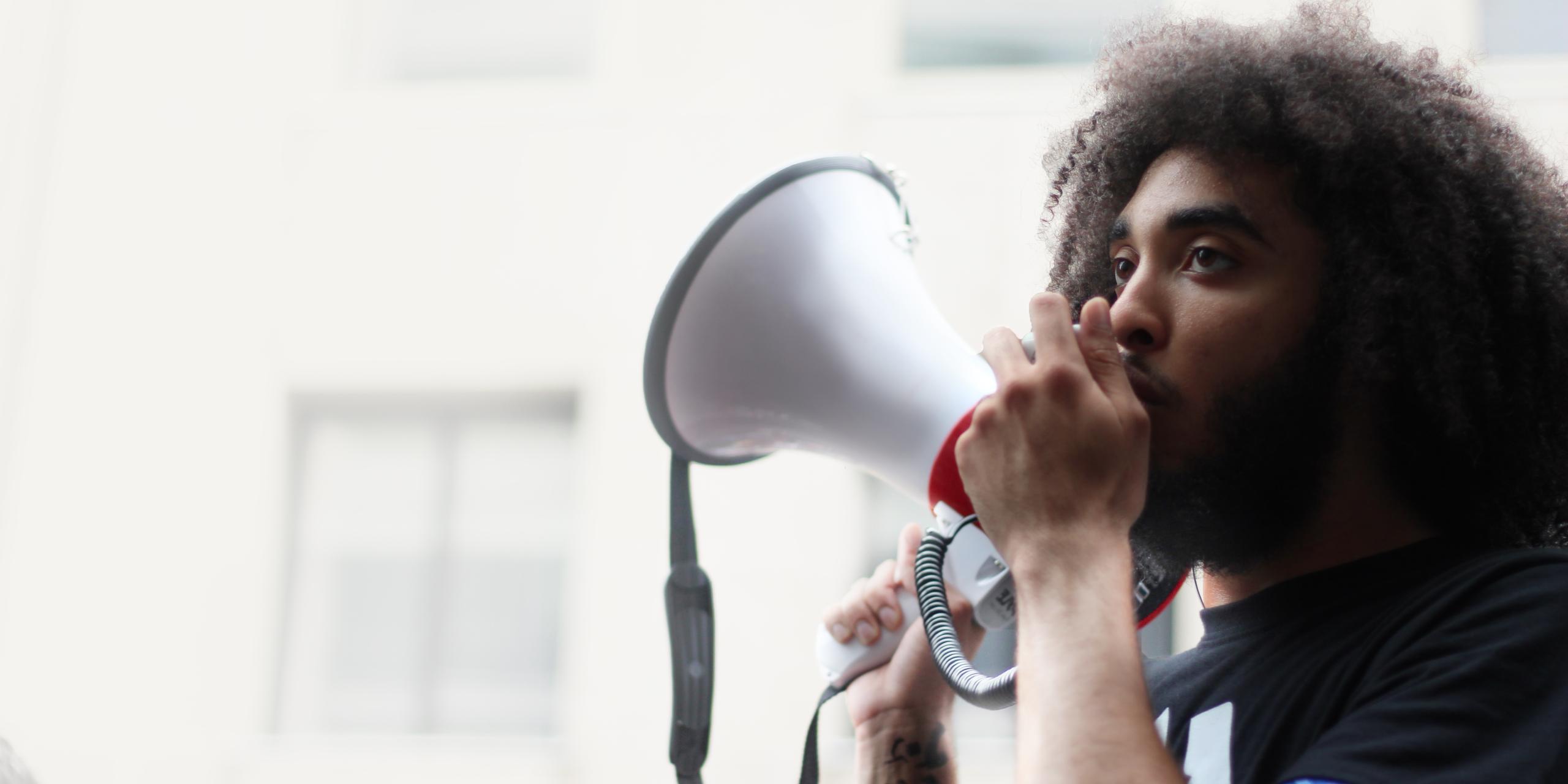 Man holding megaphone to mouth