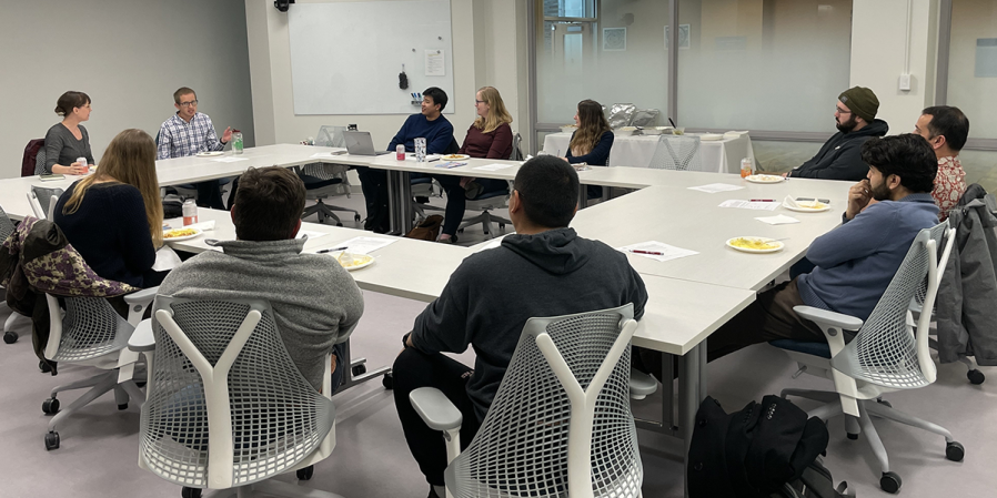 Image of social science postdoc working group meeting in 291 Clark Hall around conference table. 